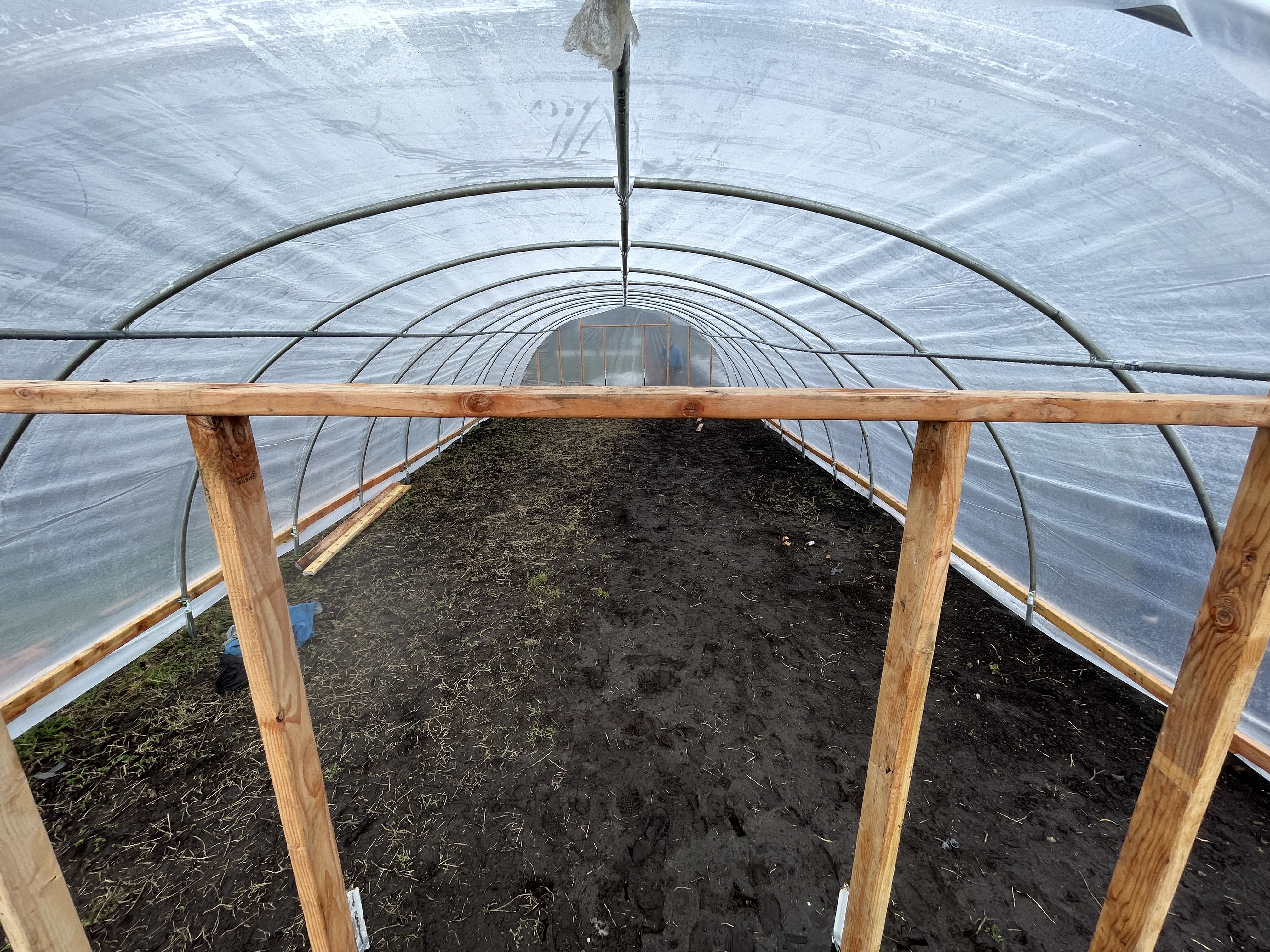 The empty inside of the completed hoop house before anything is planted inside.