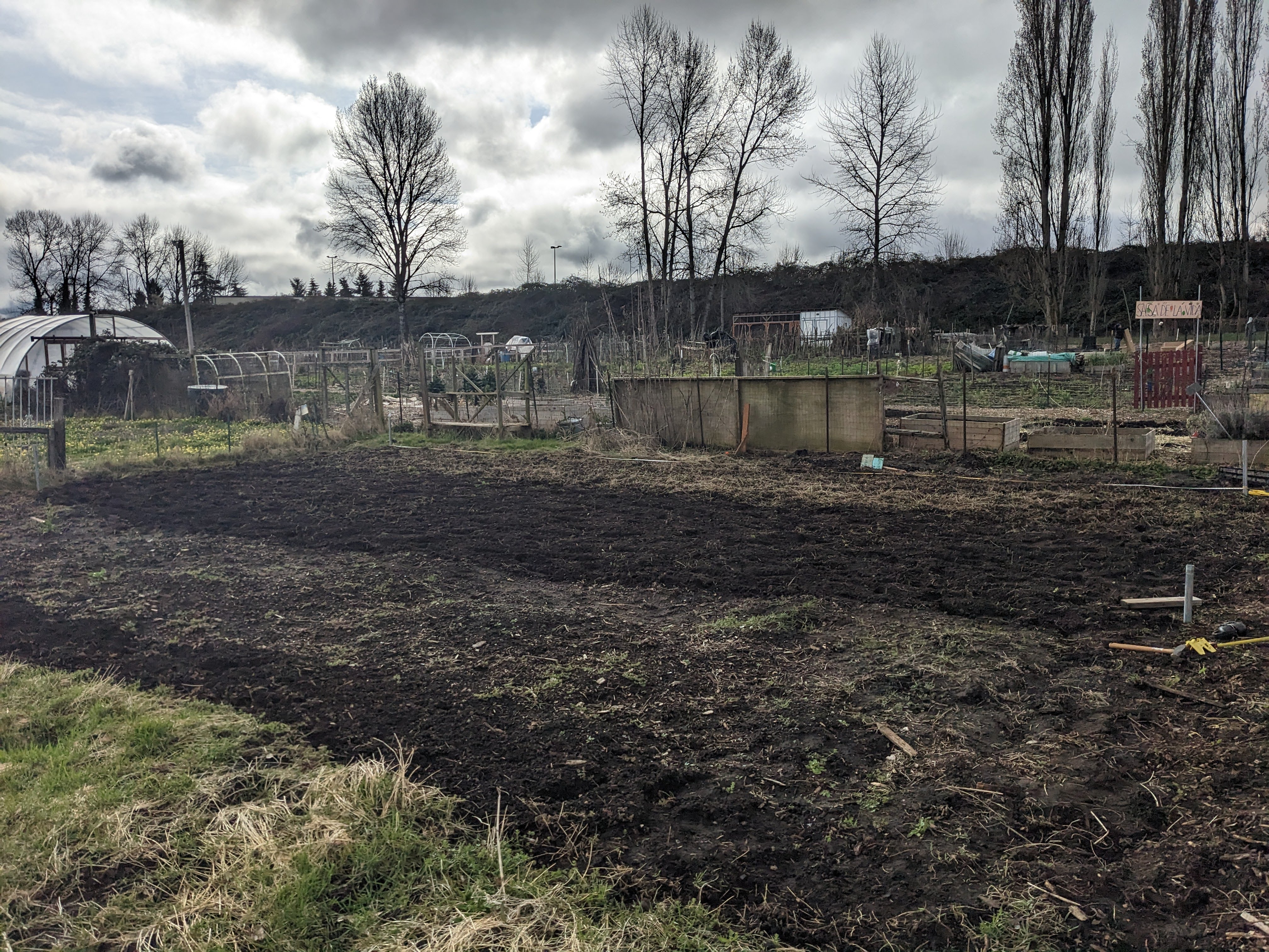 An empty expanse of farm land under a gray sky.