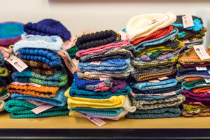 Stacks of colorful knitted hats